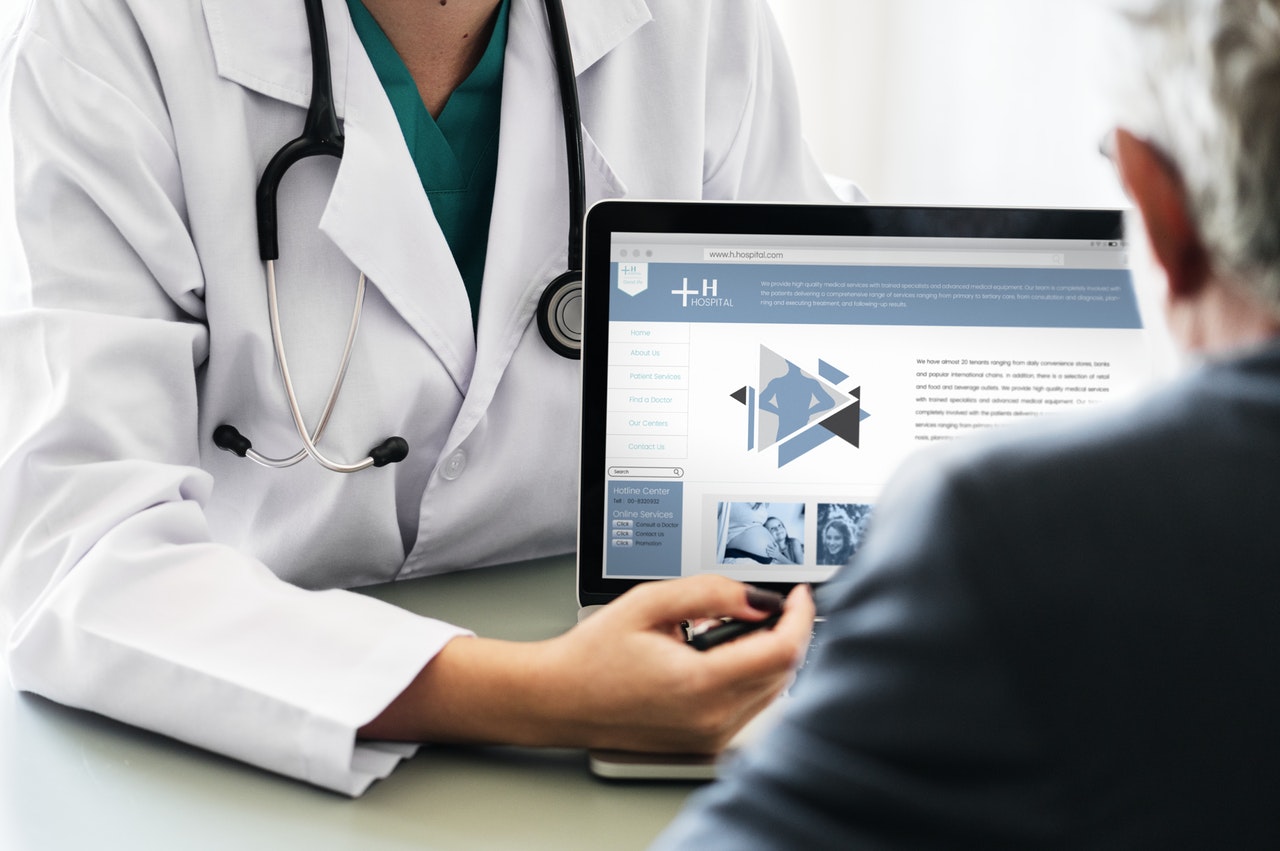 Doctor with laptop and patient